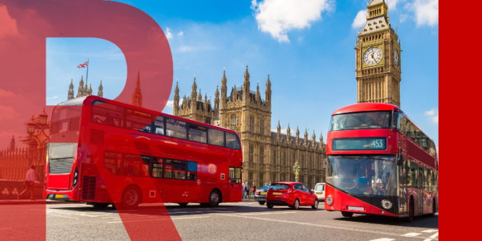 Westminster bridge with two red buses on each side of the road and Big Ben in the background against a bright blue sky.