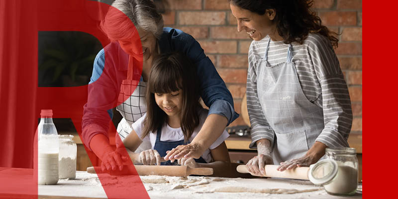 Two adults and child baking together