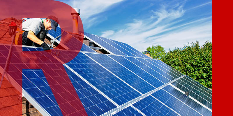 Man adding solar panels to house roof