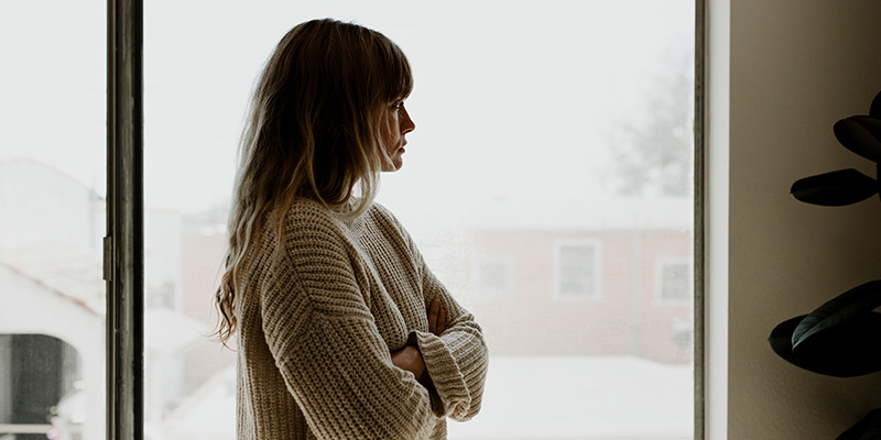Woman looking out of window