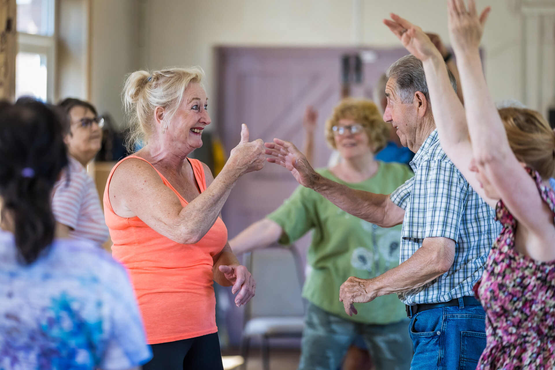 Group of people dancing in hall