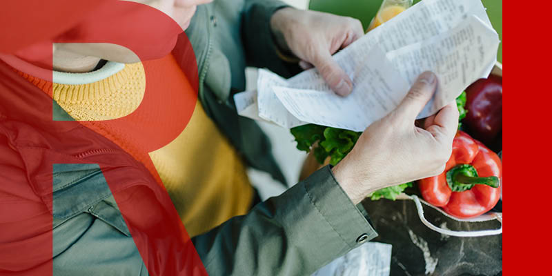 Person checking food receipt with food on the table