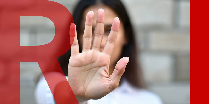 Woman holding a hand up to the viewer