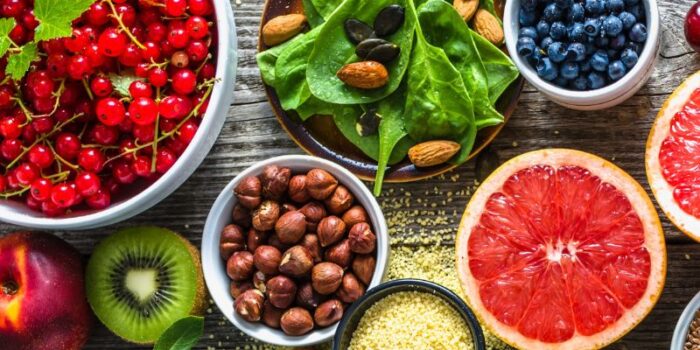 Selection of healthy food. Superfoods, various fruits and assorted berries, nuts and seeds.