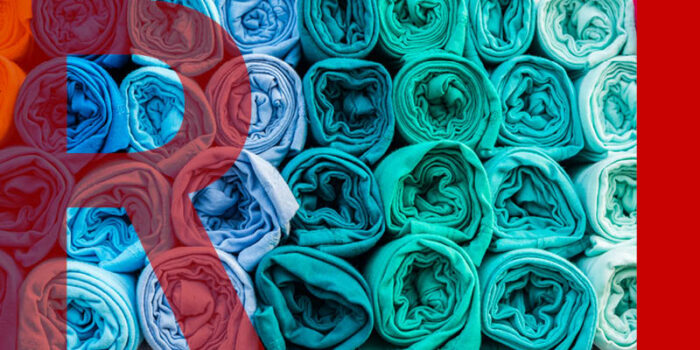 Multicoloured rolled up fabric in piles