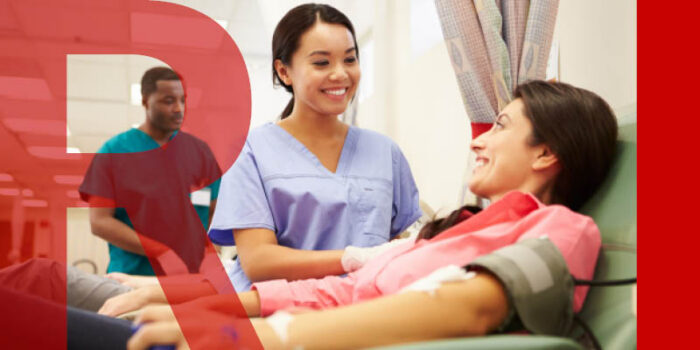 Patient lying on a medical bed while a doctor watches over them, smiling at each other