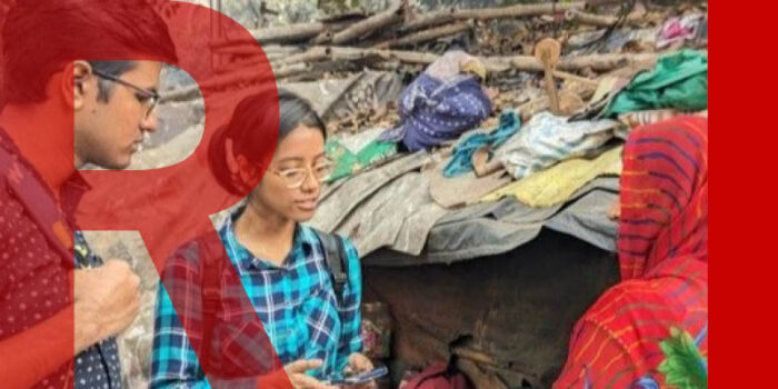 Three people talking in a slum in Kolkata